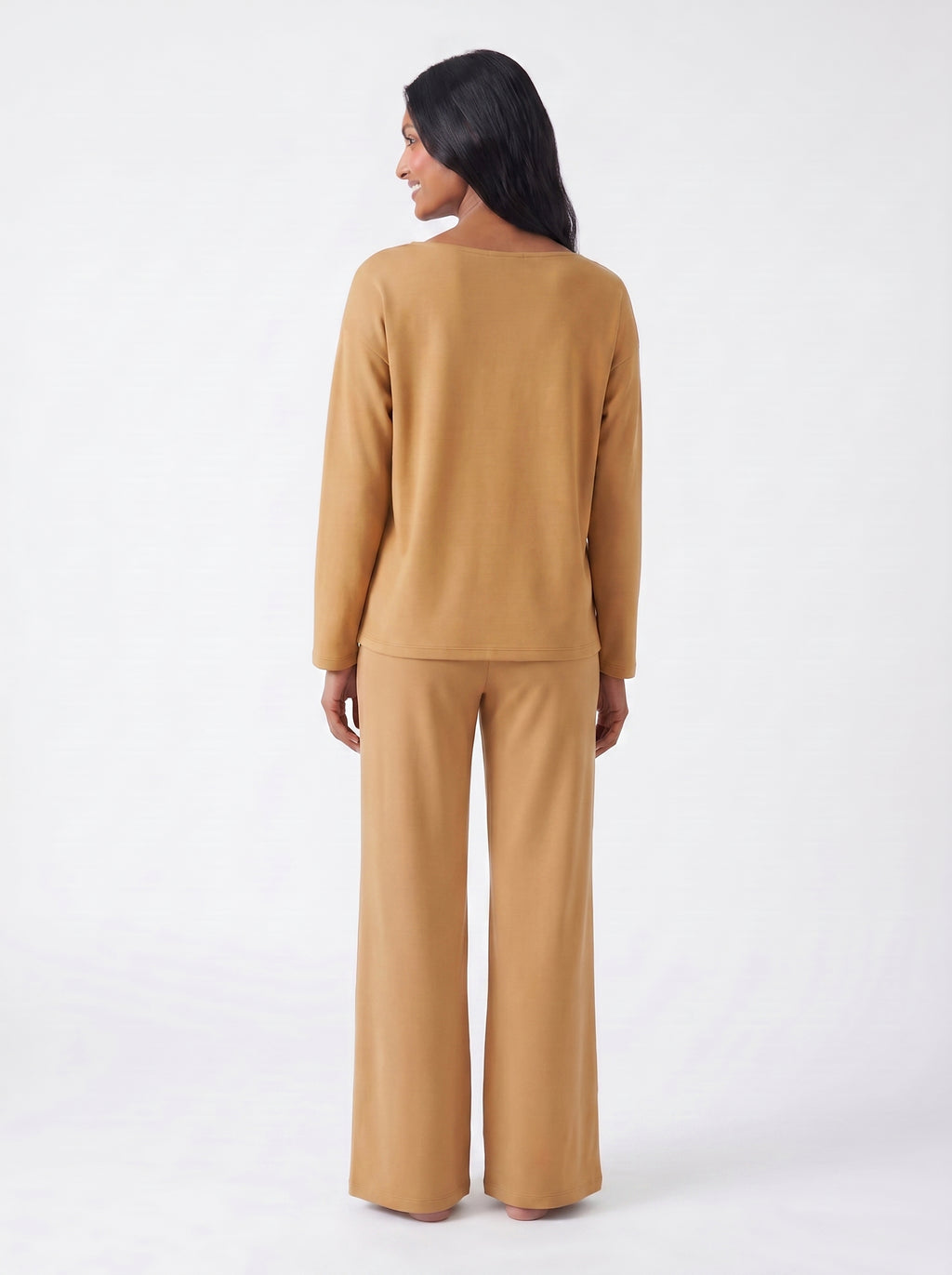 Woman wearing a Caramel bamboo loungewear set on a white background