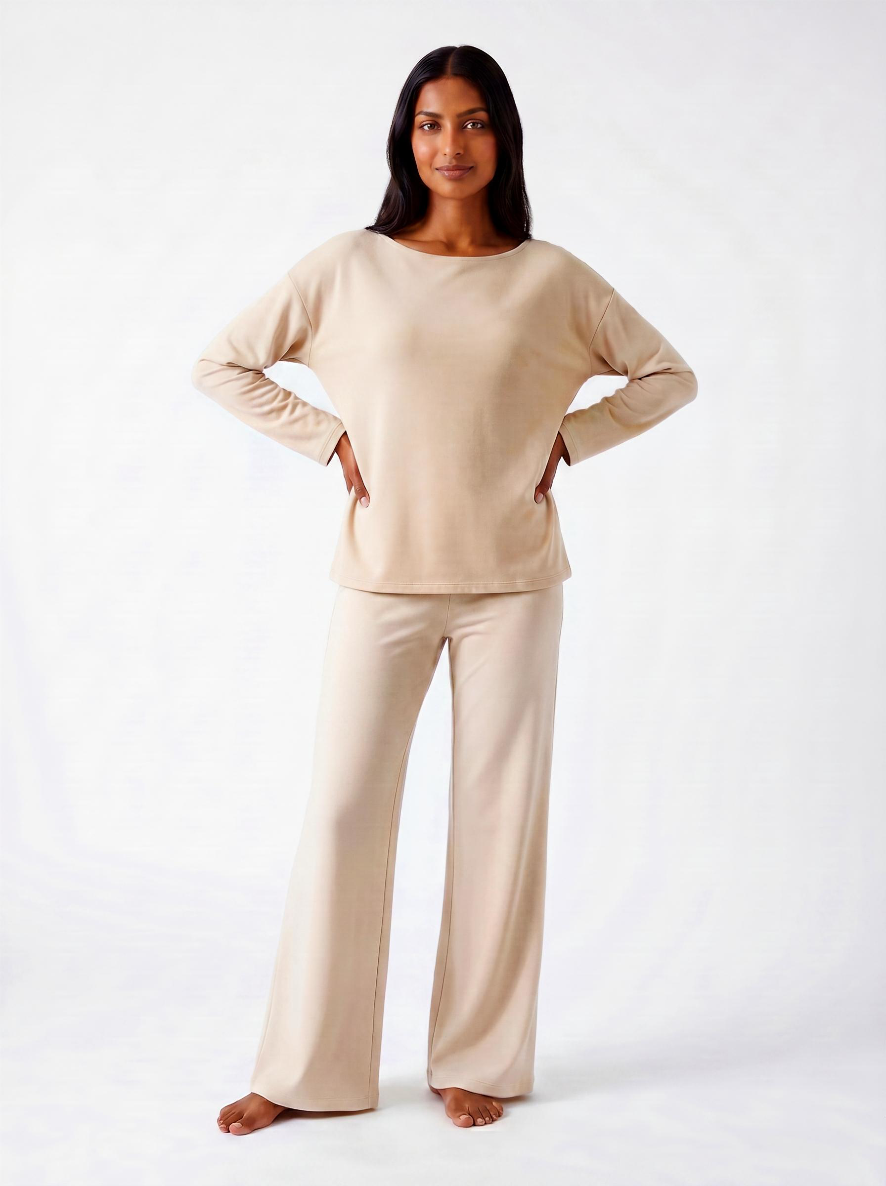 Woman wearing a warm bone bamboo loungewear set on a white background