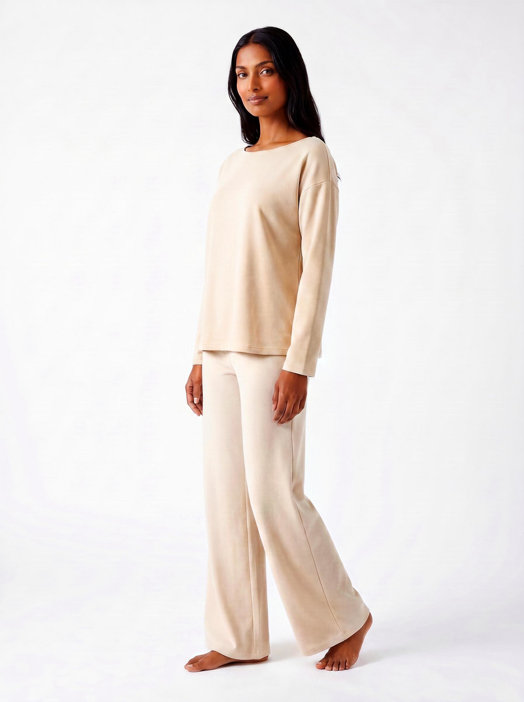 Woman wearing a warm bone bamboo loungewear set on a white background