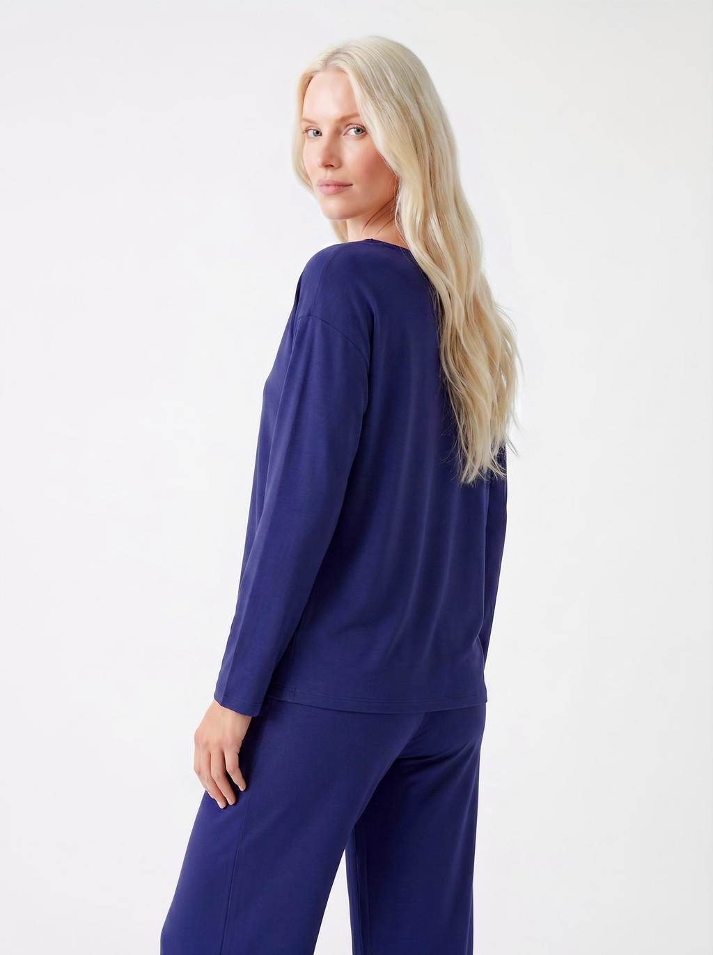 Woman wearing a Midnight blue bamboo loungewear set on a white background