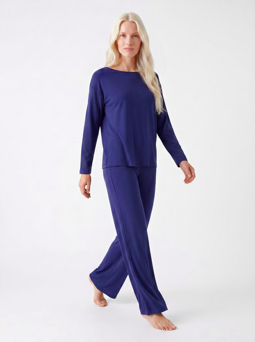 Woman wearing a midnight blue bamboo loungewear set on a white background