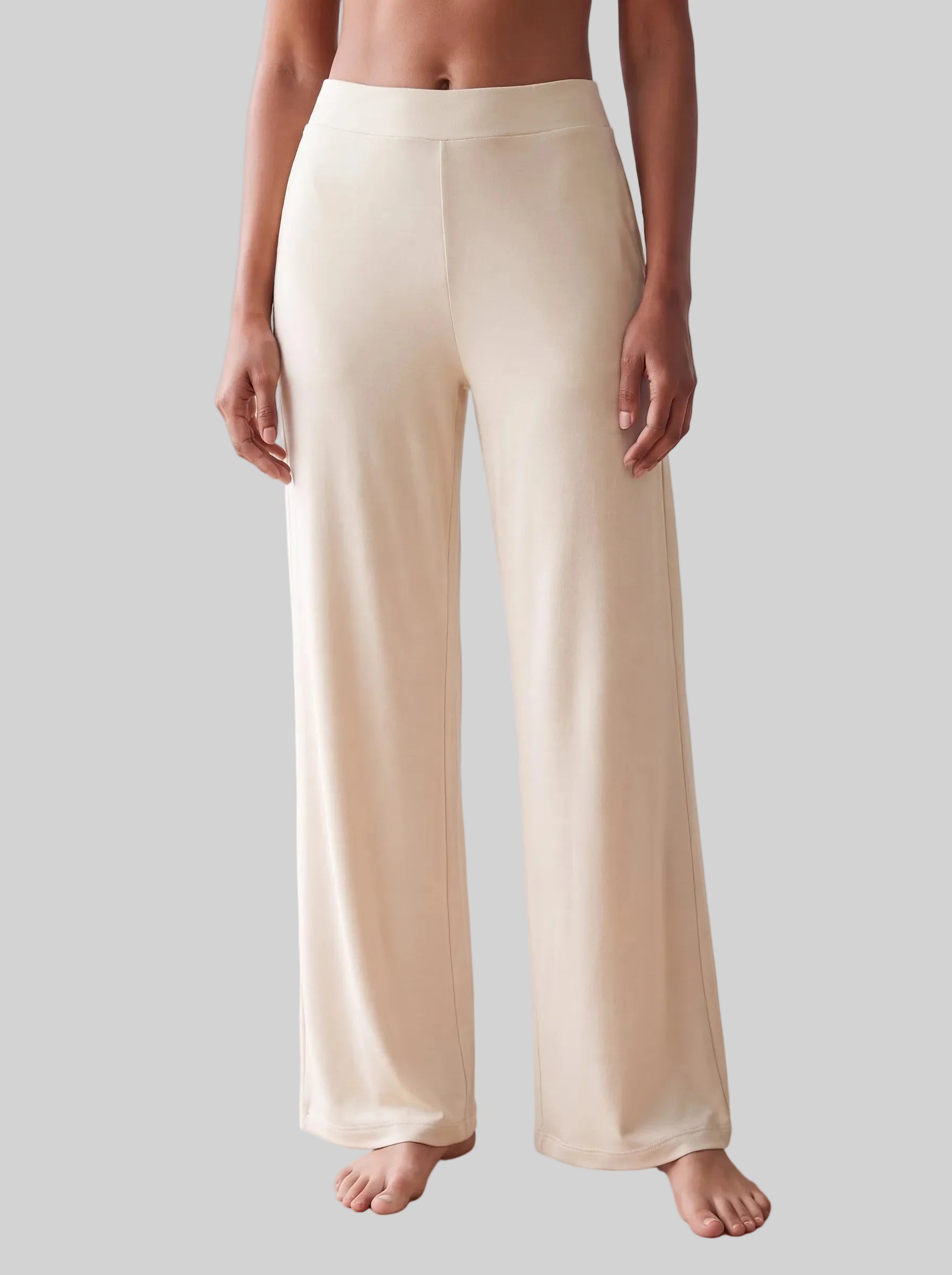 A person wearing high-waisted, wide-leg trousers 